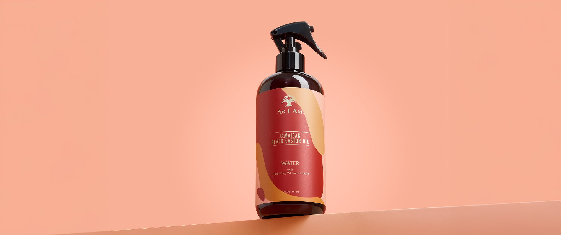 As I Am Jamaican Black Castor Oil Water - imagen de paisaje del spray hidratante sin aclarado diseñado para refrescar los rizos, hidratar el cabello seco y favorecer un crecimiento sano con JBCO.