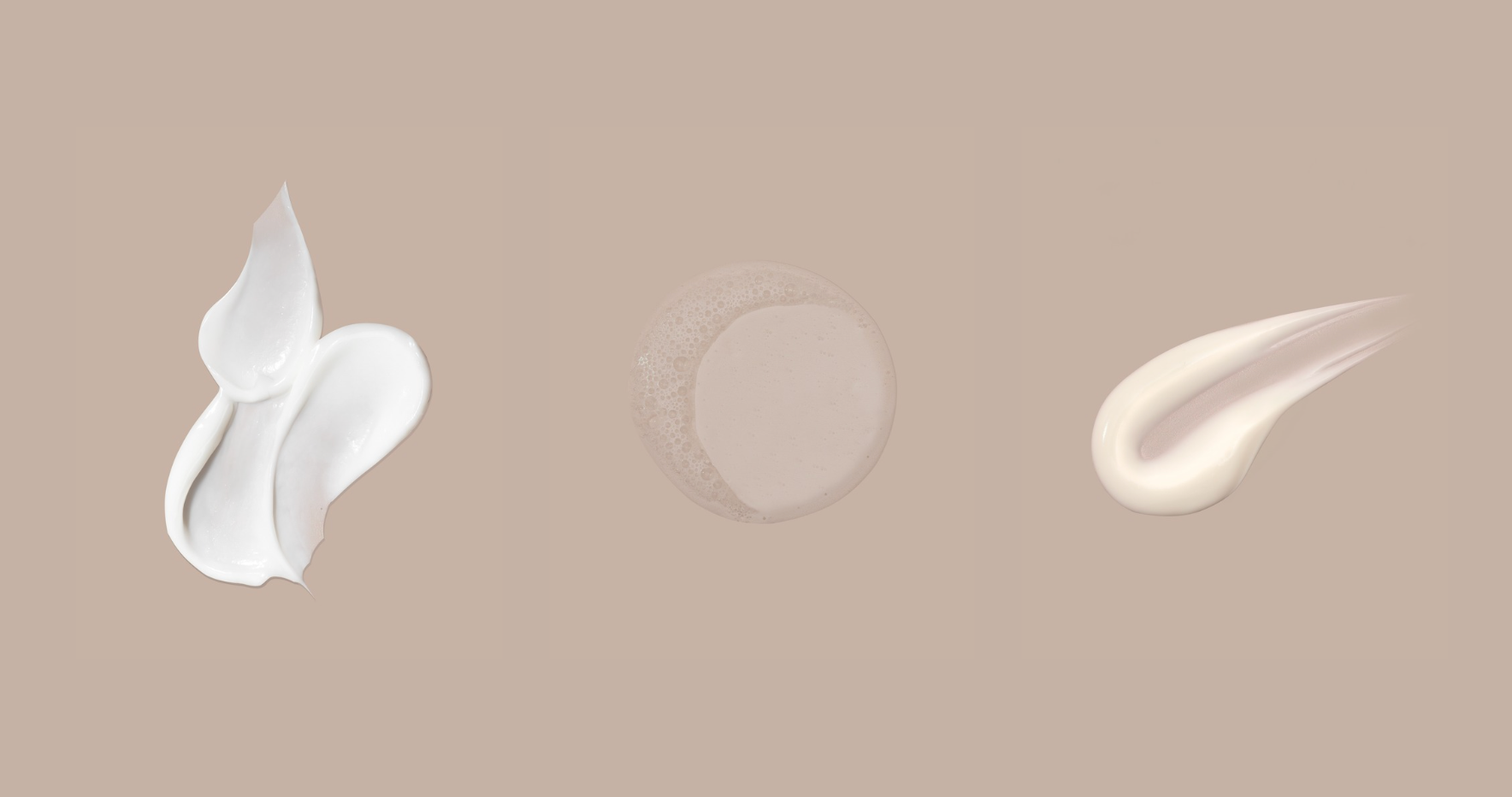 Tres muestras de crema blanca sobre fondo beige.